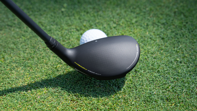 PING G430 hybrid resting behind a ball ready to swing