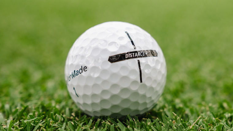 TaylorMade-distance+-golf-ball-resting-on-grass