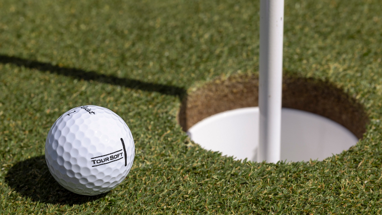 titleist-tour-soft-golf-ball-next-to-a-hole