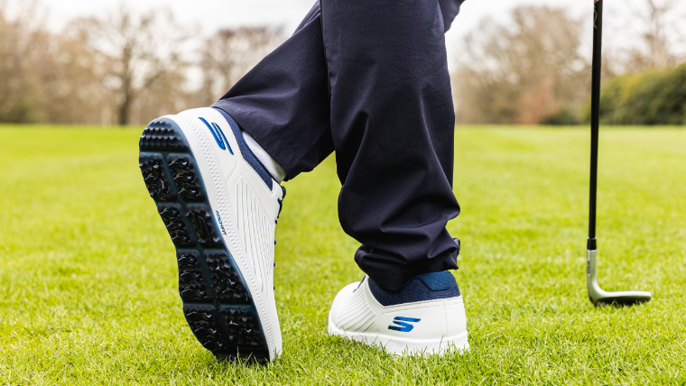a-golfer-standing-on-a-fairway-modelling-a-pair-of-skechers-elite-5-grip-flex-golf-shoes