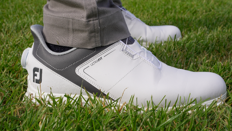 a-golfer-wearing-a-pair-of-FootJoy-UltraFIT-shoes-standing-on-grass