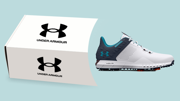 an-under-armour-golf-shoe-coming-out-of-a-shoebox