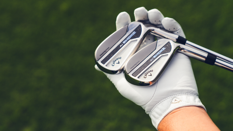 a-golfer-holding-two-callaway-irons