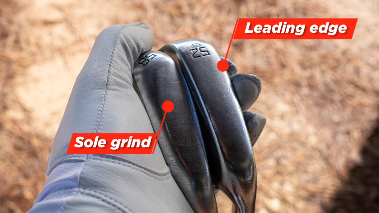labels-pointing-out-the-sole-grind-and-leading-edge-on-a-golf-wedge