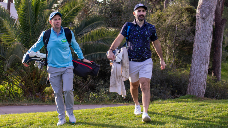 two-golfers-walking-down-a-fairway