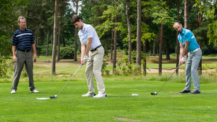 three-golfers-on-a-driving-range