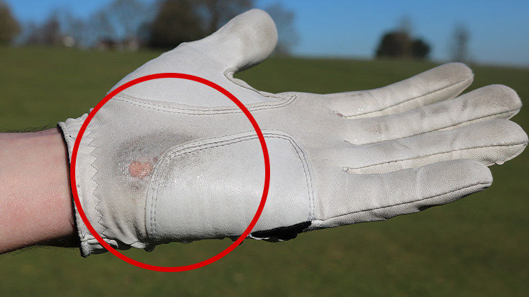 a-golf-glove-with-worn-patches-on-it