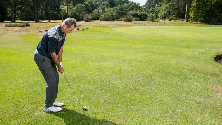a-golfer-chipping-onto-a-green