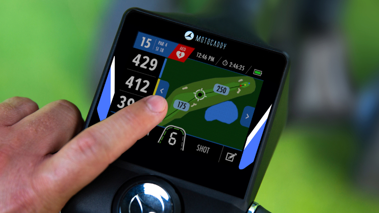 a-golfer-using-the-touchscreen-on-a-motocaddy-electric-trolley