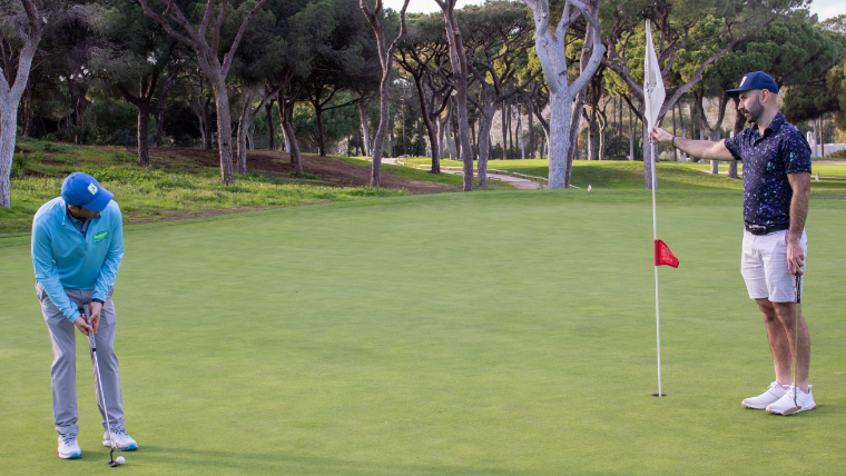 two-golfers-putting-on-a-green