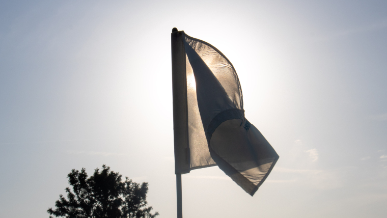 a-close-up-of-a-golf-flag