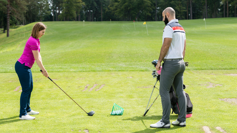 a-pro-golfer-giving-a-driving-lesson