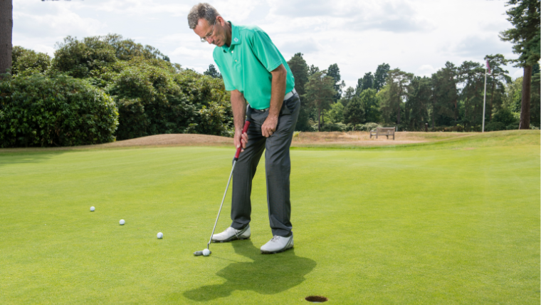 a-golfer-hitting-a-short-putt-on-a-green