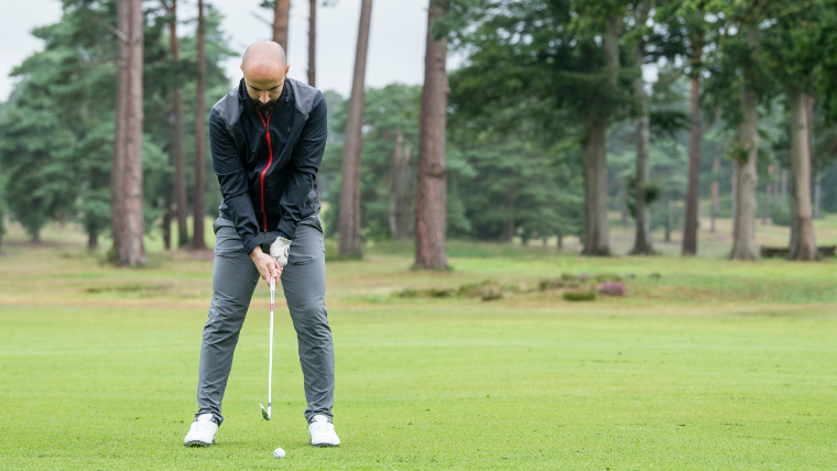 a-golfer-striking-an-approach-shot-on-a-fairway