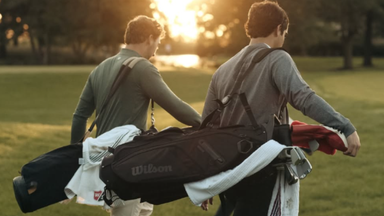 two-golfers-carrying-wilson-golf-bags