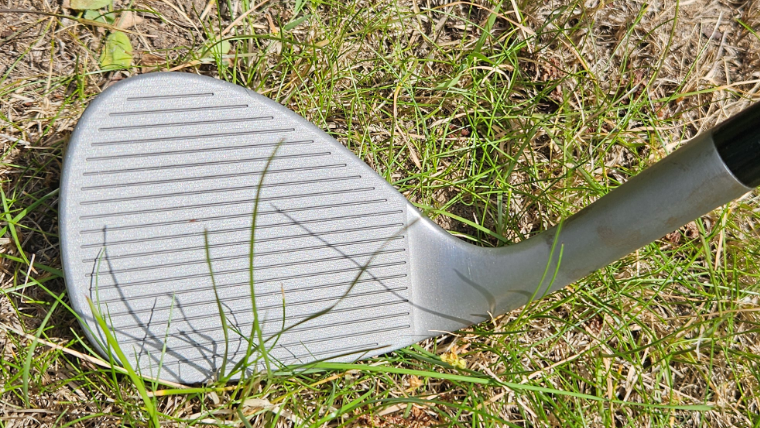 a-close-up-image-of-grooves-on-a-wedge-clubface