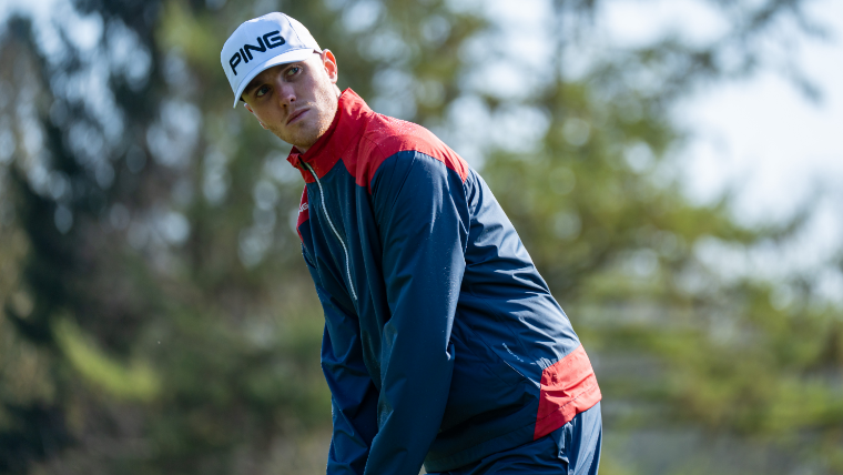 a-golfer-wearing-a-ping-waterproof-jacket