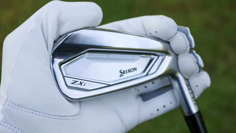 a-golfer-holding-a-srixon-zxi-iron
