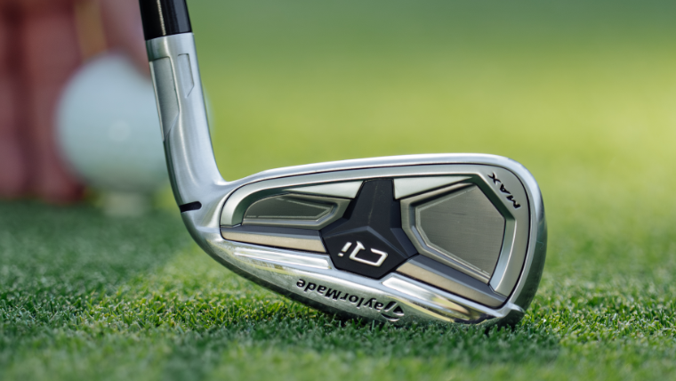 a-golfer-holding-a-taylormade-qi-max-iron