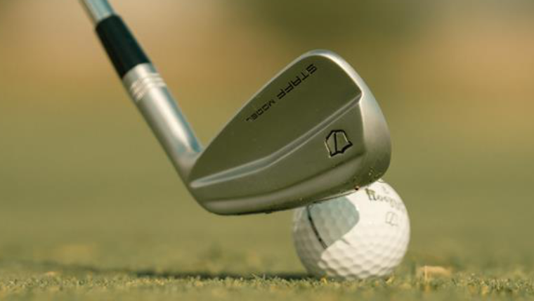 a-wilson-golf-iron-addressing-a-golf-ball