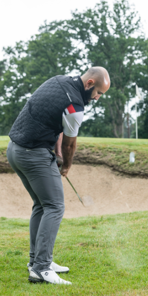 a-golfer-striking-through-a-wedge-shot