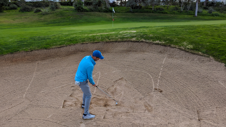a-golfer-standing-at-address-in-a-bunker