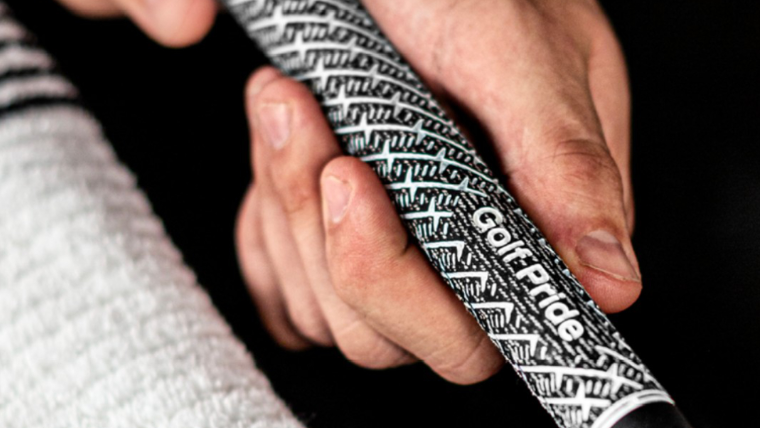 a-golfer-studying-a-golf-pride-grip