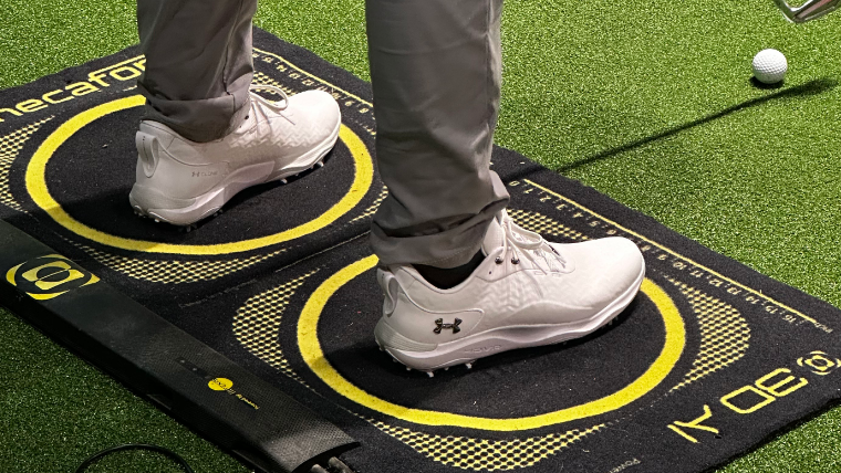 a-golfer-in-a-studio-wearing-under-armour-golf-shoes