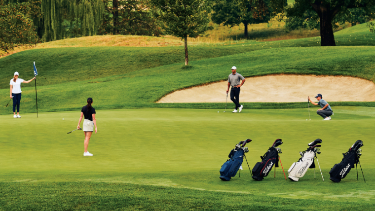 golfers-on-a-green-next-to-titleist-golf-bags