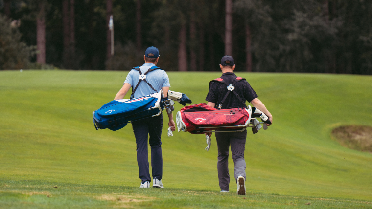 two-players-carrying-callaway-golf-bags