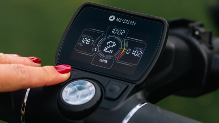 a-golfer-using-a-motocaddy-m1-electric-trolley-handle