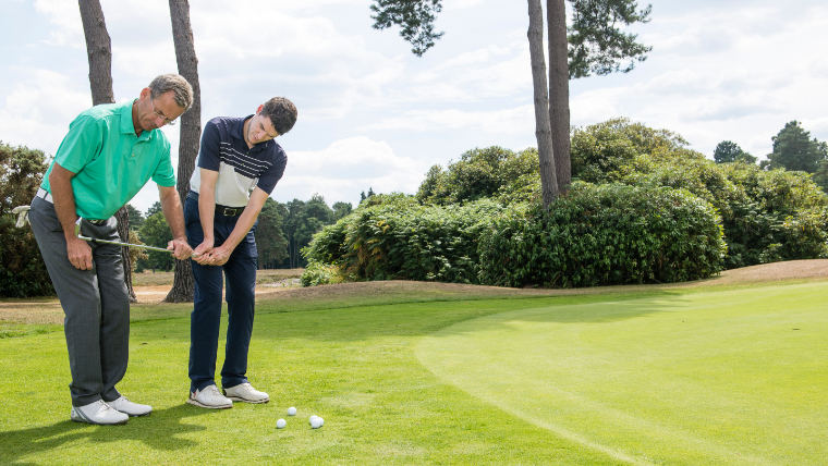 a-golf-pro-giving-a-golfer-a-lesson