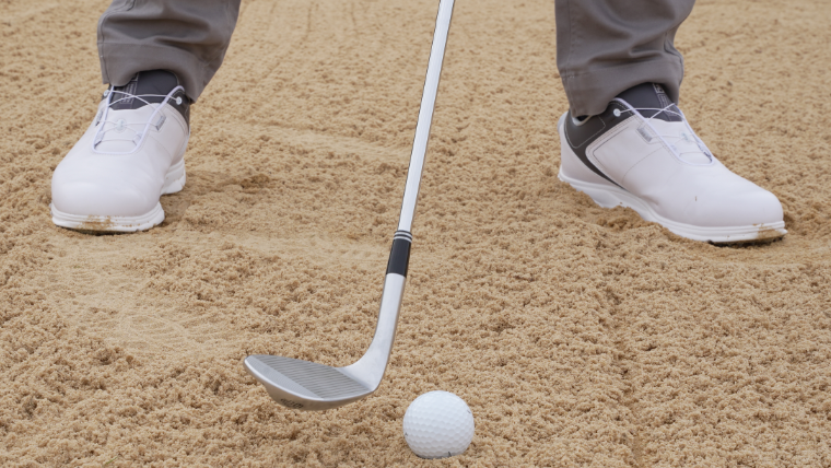 a-golfer-standing-at-address-in-a-bunker
